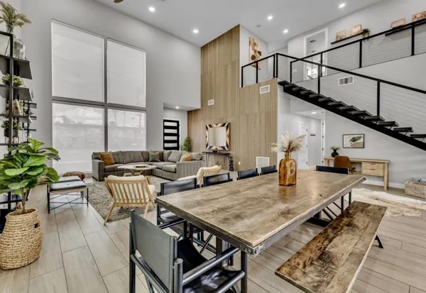 This stylish Airbnb photo shoot captures a modern open living room and loft area in Scottsdale, AZ, perfect for showcasing contemporary interior design.