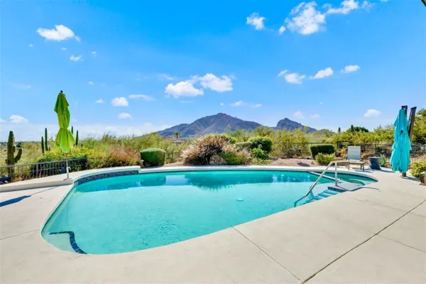 This backyard pool offers stunning mountain views in Paradise Valley, AZ, captured beautifully with professional real estate photography to highlight the outdoor living space.
