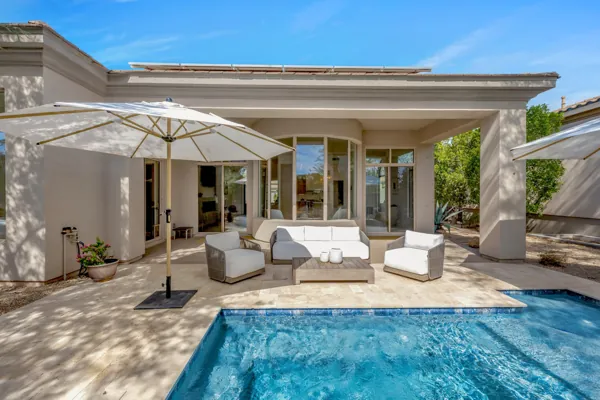 Stunning real estate photography captures a luxurious patio with pool in Scottsdale, AZ, offering a glimpse of serene outdoor living.