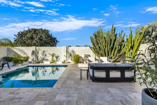 Experience luxury real estate photography showcasing a stunning backyard with pool and seating in Scottsdale, AZ.