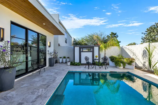 This luxury real estate photography showcases a stunning backyard pool area in Scottsdale, AZ, highlighting modern elegance and outdoor living.