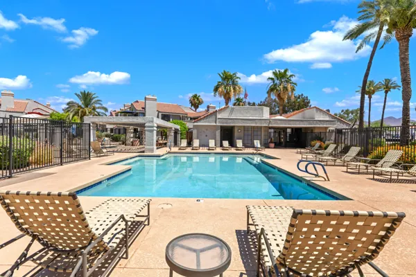 Luxurious condo amenities include a sparkling pool with lounge chairs and scenic views on E Mountain View Rd in Scottsdale, AZ.