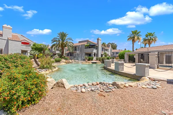 Discover a charming condo community with lush landscaping, a serene fountain, and palm trees, located on E Mountain View Rd, in Scottsdale, AZ, offering a beautiful setting and relaxed lifestyle.