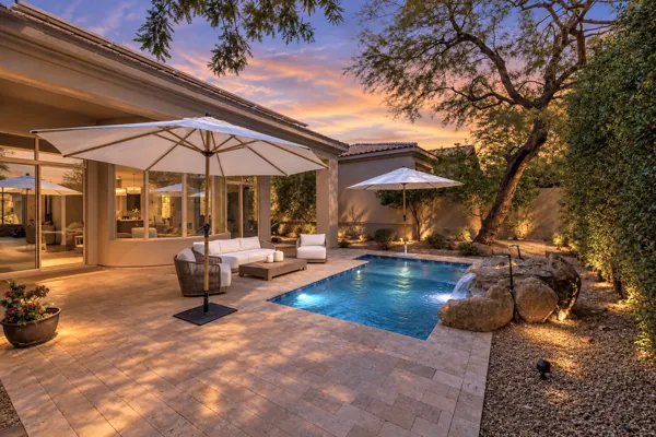 This real estate photography showcases a stunning backyard in Scottsdale, AZ, featuring a luxurious pool and seating area.