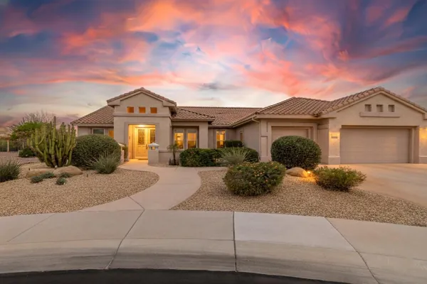 Beautiful sunset exterior of a single-story home with desert landscaping in Surprise, AZ, showcasing professional real estate photography.